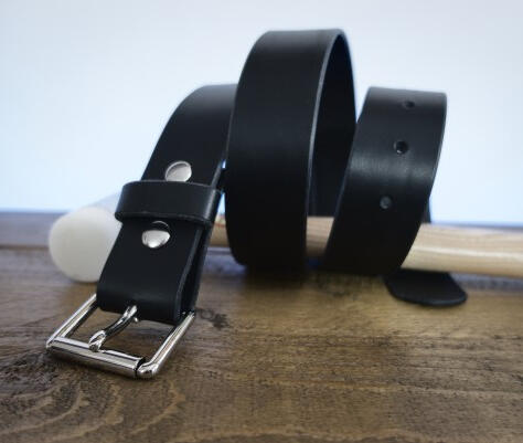 Thumbnail image of the classic collection black full grain lamport italian leather belt, curled up around a leather work hammer with silver colour hardware.
